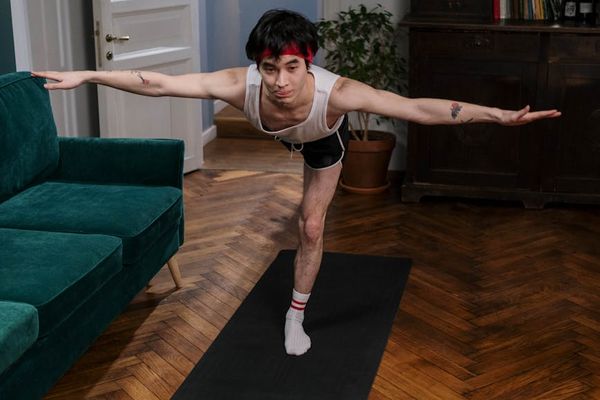 Person holding a challenging yoga pose demonstrating strength and balance.